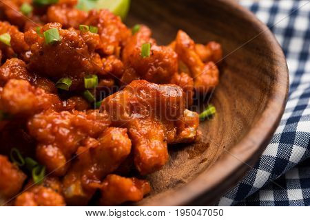 Gobi Manchurian dry - Popular street food of India made of cauliflower florets, selective focus