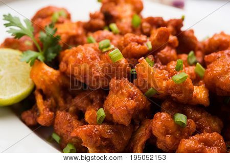 Gobi Manchurian dry - Popular street food of India made of cauliflower florets, selective focus