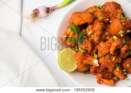 Gobi Manchurian dry - Popular street food of India made of cauliflower florets, selective focus