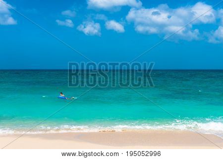 BORACAY WESTERN VISAYAS PHILIPPINES - JANUARY 14 2015: Lonely man enjoying Puka Beach with his swimming float during a sunny day.