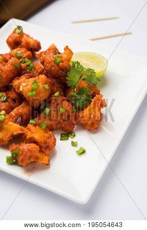 Gobi Manchurian dry - Popular street food of India made of cauliflower florets, selective focus