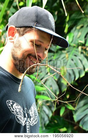 Victoria BC, Canada, July 9th 2017.A man with giant stick bugs on his face.