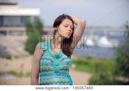 Pretty woman from Volgograd on the shore of the great Russian river Volga inflates her lips and shows her beautiful hair