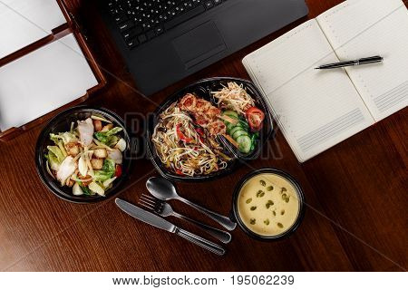 Business lunch on the desktop of the computer on one person