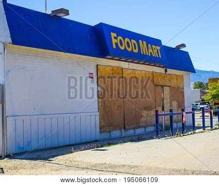 Abandoned Food Store With Boarded Up Windows
