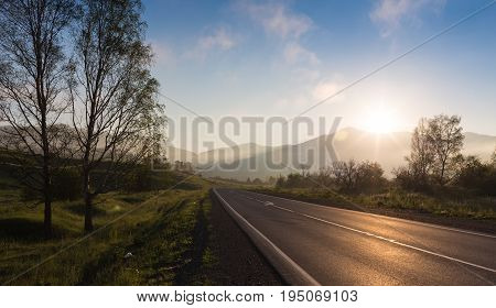 oad in sunrise time Ailai mountains, Russia.