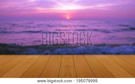 wood floor on sea with purple sunset Burning Skie beautiful natural tropical sea
