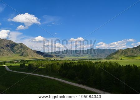 Road near village in Altai mountains. Altay Republic Siberia Russia.