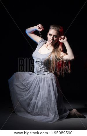 Actress In A Grey Dress On A Dark Stage