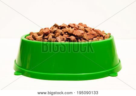 dry food for pets in green plastic bowl