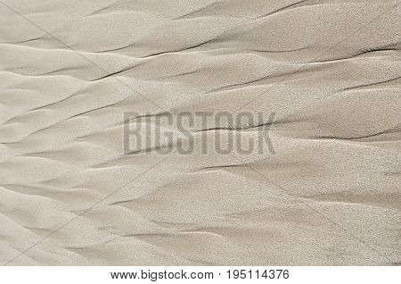 Geometric patterns on the beach sand. Warm tones. View from above