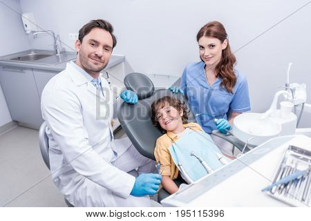 Dentists Preparing Little Boy For Examining Teeth At Dentist Office