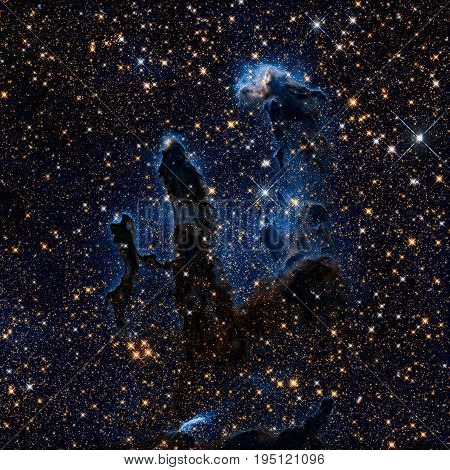 The Pillars of Creation. Infrared view of the Eagle Nebula or M16. It is a young open cluster of stars in the constellation Serpens. Retouched colored image. Elements of this image furnished by NASA.