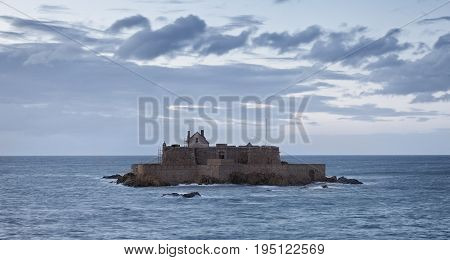 Dusk image of The Fort National from Saint Maloin Brittany in northwestern France during the high tide time.The construction was used first as a reference point for the ships and from 1869 became a defensive bastion against the English attacks.