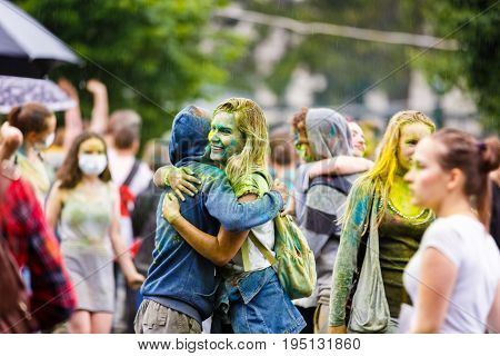 Kaliningrad Russia - July 08 2017: Young people are celebrating the Holi festival during the city day of Kaliningrad in rainy weather