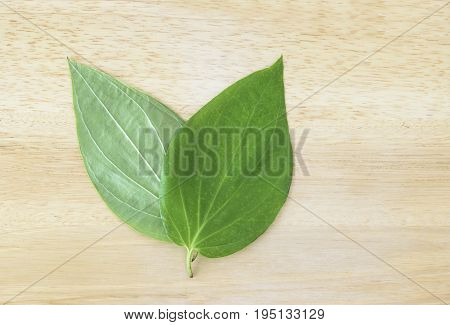 Betel leaves (pan patta) on a wooden background