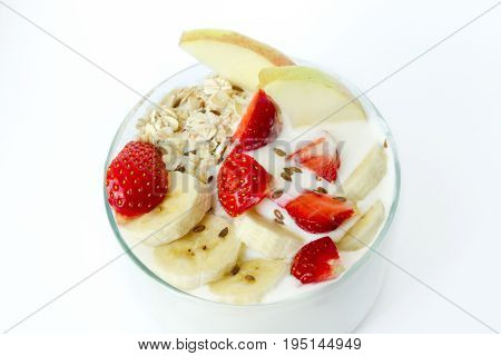 Glass Of White Yogurt With Banana, Oat Flakes, Strawberry, Flax Seeds On A White Background Close-up