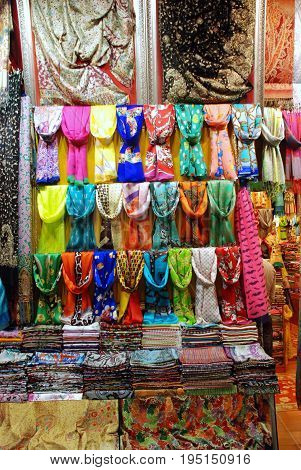 Colorful display of pashmina scarves in store window