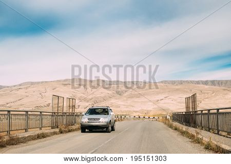 Gori, Shida Kartli Region, Georgia. SUV Car On Country Road In On Autumn Landscape Background Of Kartli Valley.