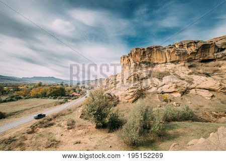 Shida Kartli Region, Georgia. Car Parking On Roadside Near Road To Uplistsikhe. Uplistsikhe Is An Ancient Rock-hewn Town. Landscape In Sunny Autumn Day.