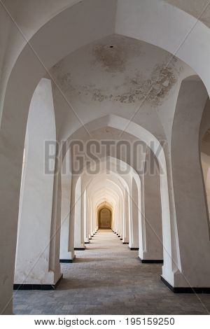 Arched hallway perspective at Mir-i-Arab medressa in Bukhara Uzbekisan.