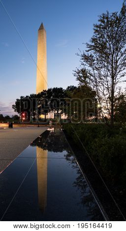 Reflection of Washington Monument at sunset in the polished top of a marble bench