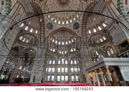 Istanbul, Turkey - April 21, 2017: Fatih Mosque a public Ottoman mosque in the Fatih district of Istanbul Turkey with a huge decorated domes & many colored stained glass windows