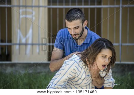 guy making the heimlich maneuver to a girl while she's choking