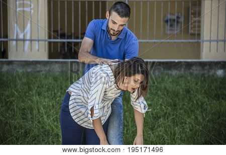 guy making the heimlich maneuver to a girl while she's choking