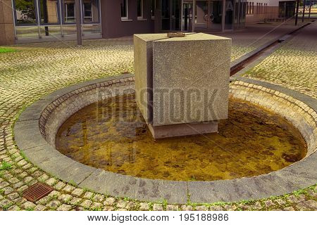 a concrete dice in front of a building