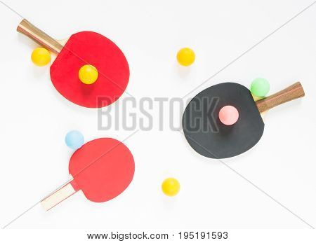 Sport background. Red and black ping-pong rackets and balls. Flat lay top view.