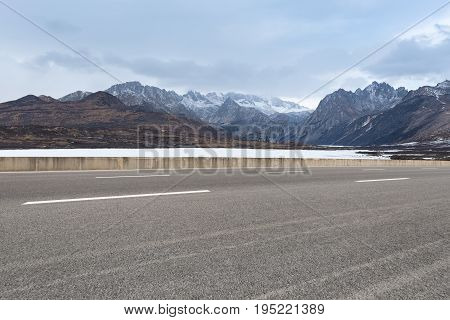 empty road with and ice lake in tibetan plateau asphalt highway background