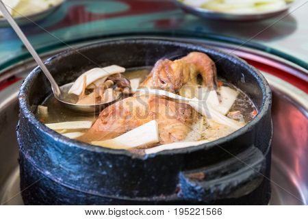 tibetan delicious food in stone pot to boil chicken with some wild fungus mushroom