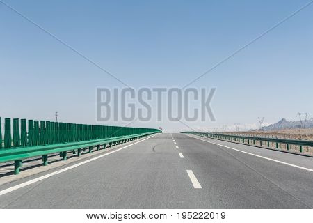 highway on gobi desert empty road with wilderness background