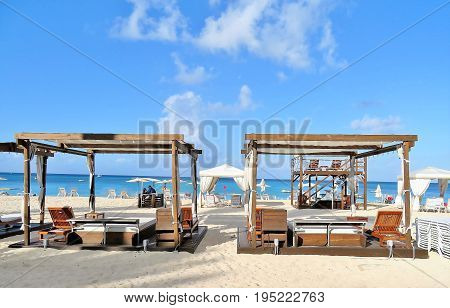 Beach cabanas and chairs on a white sandy beach