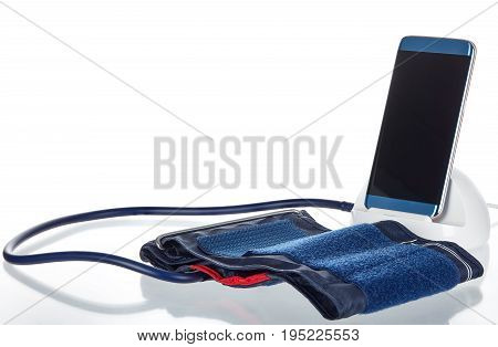 Electronic smart blood pressure monitor or sphygmomanometer with a phone or tablet hooked up to an inflatable arm cuff. This device is the modern version of the traditional medical instrument for health care.