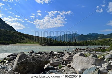 Stream of Katun river flows between stones forest and hills in Altai mountains. Altay Republic Siberia Russia.
