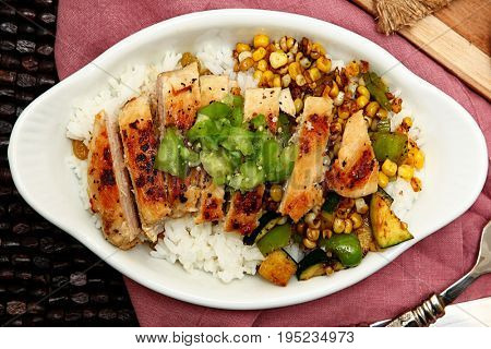 Seared Chicken and Tomatillo Salsa in white bowl on table.