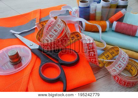 tailor workspace with sewing and handmade tools. tools for sewing for hobby. instruments sewing craft on wooden background close up