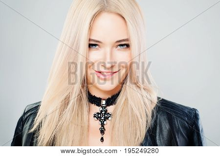 Beautiful Blonde Woman with Blonde Hair and Gothic Jewelry Necklaces. Blondie Fashion Model with Shiny Hairstyle and Natural Makeup
