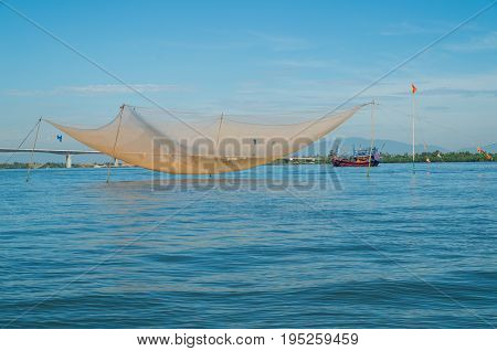 Vietnamese fishing boats on the Vin Cura Dai river, the mouth of the Thu Bon river near Hoi An in Vietnam.