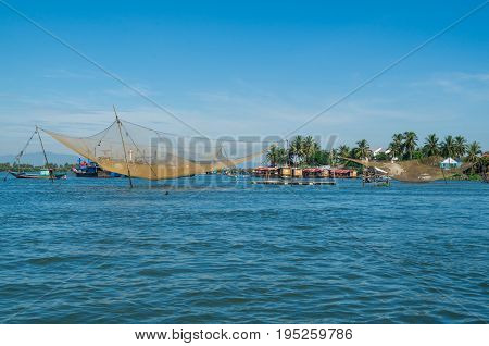 Vietnamese fishing boats on the Vin Cura Dai river, the mouth of the Thu Bon river near Hoi An in Vietnam.