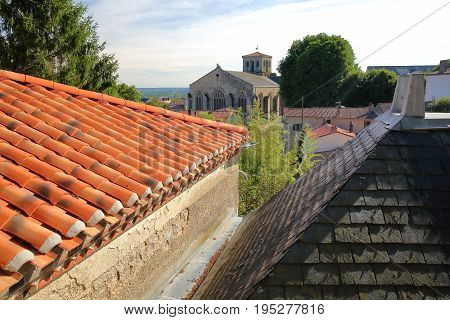Roofs of traditional houses with St Jacques Church in the background, Pouzauges, Vendee, France