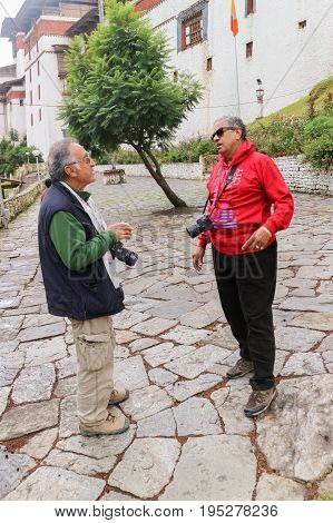 Trongsa Bhutan - September 12 2016: Two Caucasian men chatting near the Trongsa Dzong Bhutan