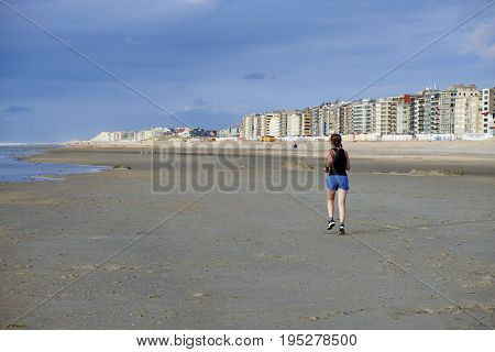 Woman Jogging On The Beach