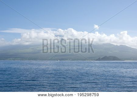 View of Maui with Molokini Crater. Molokini is popular for scuba diving and snorkeling