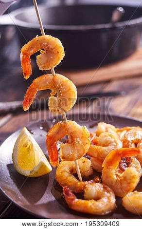 Vertical shot of shrimps barbeque on stick. Close up.