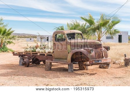 GROBLERSHOOP SOUTH AFRICA - JUNE 11 2017: The wreck of an old truck with a load of gourds at a farm stall on the N10 road between Groblershoop and Upington in the Northern Cape Province
