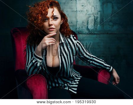 woman siting on red chair in nice interier
