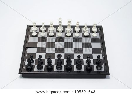 Chess black player side on white background. Table game chess photo. Chess figures position for game start. Chessboard with figures. Business strategy concept. Tactic decisions competition game chess